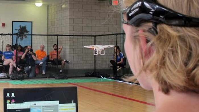 In this April 16, 2016 photo. a University of Florida student uses a brain-controlled interface headset to fly a drone during a mind-controlled drone race in Gainesville, Fla. For more than a century science has been able to detect brainwaves, but recent advances in cheaper equipment like the electroencephalogram, or EEG, headsets worn by the drone racers is moving the technology out of the lab.