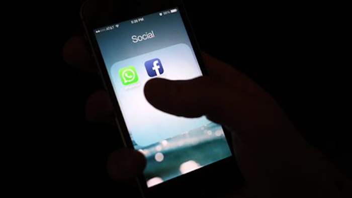 This Feb. 19, 2014, file photo shows the Facebook app icon on an iPhone in New York. A feature rolling out Tuesday, April 5, 2016, on Facebook's iPhone app interprets what's in a photo using a form of artificial intelligence to recognize faces and objects for blind and visually impaired people as they scroll through the pictures posted on the world's largest online social network.