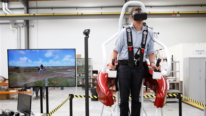 In this Feb. 9, 2016 photo, test pilot Michael van der Vliet operates a flight simulator at the Martin Aircraft Co. headquarters in Christchurch, New Zealand.