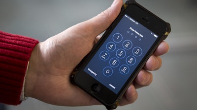 FILE - In this Feb. 17, 2016 file photo, an iPhone is seen in Washington. The FBI said that it will not publicly disclose the method that allowed it to break into a locked iPhone used by one of the San Bernardino attackers, saying it lacks enough “technical information” about the software vulnerability that was exploited.