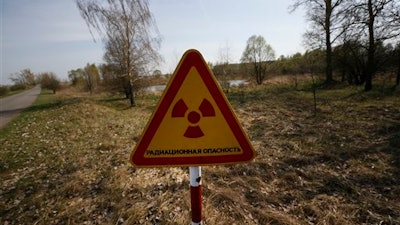 This sign is placed a mere two kilometers from Nikolai Chubenok farm, where milk has tested at 10 times safe levels of radiation.