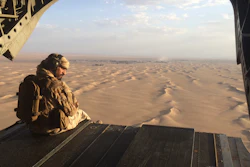 In this file photo, an Emirati gunner watches for enemy fire from the rear gate of a United Arab Emirates Chinook military helicopter flying over Yemen. The United Arab Emirates is taking part in regional conflicts and likely has spent into the billions of dollars to support its military in 2015 as well, a new report revealed. Both the UAE and Saudi Arabia also sent troops into Bahrain to put down its 2011 Arab Spring-inspired protests.