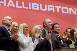 In this file photo, Halliburton Chairman, President and CEO David Lesar, third from right, rings the New York Stock Exchange opening bell. Halliburton and Baker Hughes announced their plan to combine in November 2014. The U.S. Justice Department is expected to sue to stop the acquisition, but the lawsuit had not yet been announced.