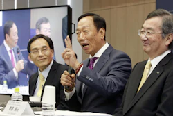 Hon Hai Precision Industry Co. Ltd., also known as Foxconn, Chairman Terry Gou, center, answers a reporter's question next to Sharp President Kozo Takahashi, right, during a press conference.