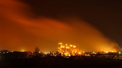 A plume of smoke rises over the State oil company Petroleos Mexicanos' petrochemical plant in Coatzacoalcos, Mexico, Wednesday April 20, 2016. An explosion ripped through a petrochemical plant on the southern coast of the Gulf of Mexico on Wednesday, killing 3 people, injuring dozens and sending flames and a toxin-filled cloud into the air, officials said.