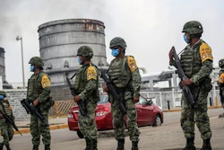 Mexican army soldiers wearing protective face masks stand guard at an entrance of the Pajaritos petrochemical complex in Coatzacoalcos, Mexico, Thursday, April, 21, 2016. At least 13 people are now confirmed dead and scores of others were injured in a Wednesday afternoon explosion inside the plant. The state oil company Petroleos Mexicanos, or Pemex, said the plant, operated by Mexichem, in partnership with Pemex, produces vinyl chloride, a hazardous industrial chemical.