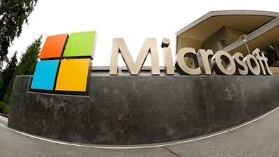 This file photo, shows the Microsoft Corp. logo outside the Microsoft Visitor Center in Redmond, WA. In a lawsuit filed Thursday, April 14, 2016, Microsoft is suing the U.S. government over a federal law that lets authorities examine its customers’ email or online files without the customers’ knowledge.