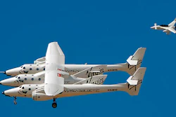 A chase plane flies on the tail of the WhiteKnightTwo and SpaceshipTwo as it soars above the runway of Spaceport America in Upham, NM, during the 2010 runway dedication ceremony. A team of pilots, ground crew and mission control specialists are at the spaceport for a week of air and ground testing in preparation for future commercial space flights at the remote patch of desert in Sierra County.
