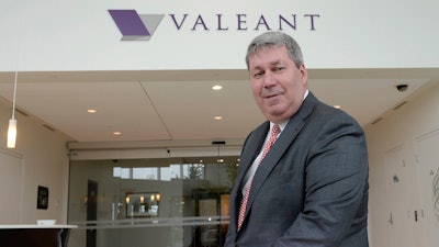 Valeant Pharmaceuticals CEO J. Michael Pearson poses at the company's annual meeting in Montreal. Valeant asked him to cooperate with a Senate investigation into drug pricing after he failed to appear for a deposition.