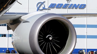 In this Tuesday, Feb. 16, 2016, file photo, an engine and part of a wing from the 100th 787 Dreamliner to be built at Boeing of South Carolina's North Charleston, S.C., facility are seen outside the plant. Boeing reports financial results on Wednesday, April 27, 2016.