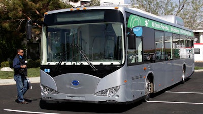 In this May 1, 2013, file photo, an electric bus produced by China's BYD Co., is parked at the announcement of the opening of an electric bus manufacturing plant in Lancaster, Calif. The Chinese automaker that sold more electric cars last year than Tesla, Nissan and GM combined is taking a back road into the American market on a battery-powered bus.