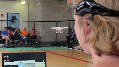 In this April 16, 2016 photo. a University of Florida student uses a brain-controlled interface headset to fly a drone during a mind-controlled drone race in Gainesville, Fla. For more than a century science has been able to detect brainwaves, but recent advances in cheaper equipment like the electroencephalogram, or EEG, headsets worn by the drone racers is moving the technology out of the lab.