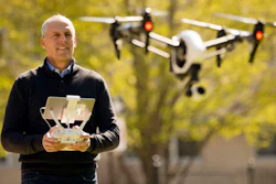 In this Thursday, April 14, 2016, photo, DroneLinx CEO Steve Metzman operates a drone to make videos and still images of an apartment building, in Philadelphia. DroneLinx, a service based in New York, takes shots of cellphone towers, bridges, oil rigs and utility lines that are difficult to get careful inspections of, Metzman says.