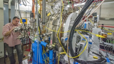 Berkeley Lab's Fernando Sannibale inspects the APEX (Advanced Photoinjector Experiment) that has served as a test electron gun and injector system for LCLS-II. The LCLS-II injector system will be located at the future X-ray laser's front end. It will produce bunches of electrons for the generation of X-ray pulses that are only quadrillionths of a second long, at rates of up to a million bunches per second.