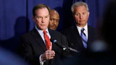 Michigan Attorney General Bill Schuette addresses the media, Wednesday, April 20, 2016, in Flint, Mich. Months after officials conceded that a series of bad decisions had caused a disaster, charges were filed against a pair of state Department of Environmental Quality employees and a local water treatment supervisor and stem from an investigation by the office of the attorney general.