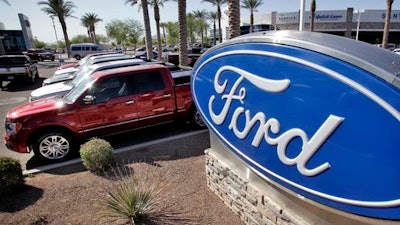 In this March 29, 2011 file photo, new 2011 Ford F-150 trucks are shown at a dealership in Glbert, Ariz. Ford is recalling nearly 202,000 pickup trucks, SUVs and cars in North America because the automatic transmissions can suddenly downshift to first gear.