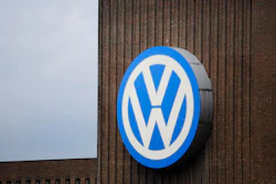 A security guard stands on the roof of the Volkswagen old power plant and monitors the area during the company's annual press conference in Wolfsburg, Germany, Thursday, April 28, 2016.