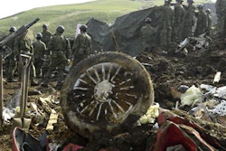 Members of the Japan Self-Defense Forces work to retrieve the body of a missing person found at the site of a landslide in Minamiaso, Kumamoto prefecture, Japan Tuesday, April 19, 2016. Minamiaso, a town of 12,000 on the southern island of Kyushu, was partly cut off by landslides and road and bridge damage after earthquakes.