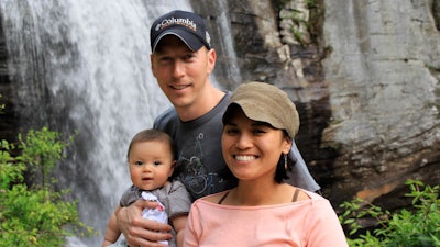 In this 2012 photo provided by Jamie Gilpin, Gilpin, center, poses for a photo with his wife, Joy Cadelina Gilpin, right, and daughter, Celeste Gilpin, at Looking Glass Falls, Pisgah National Forest, near Asheville, N.C. Small businesses in North Carolina are worried about fallout from the new state law limiting protections for gay, lesbian, bisexual and transgender people. Jamie Gilpin said that his bicycle tours business has seen a decline in inquiries since the law was passed.