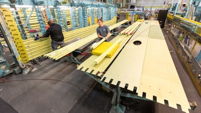 Production Operations team members work on a wing that is part of the first LM-100J commercial freighter at the Lockheed Martin site in Marietta, Georgia. The LM-100J is the commercial variant of the proven C-130J Super Hercules.