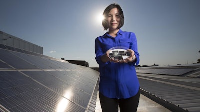 Dr. Xiaojing Hao of UNSW's Australian Centre for Advanced Photovoltaics holding the new CZTS solar cells.