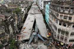 General view shows a partially collapsed overpass in Kolkata, India, Friday, April 1, 2016. The overpass spanned nearly the width of the street and was designed to ease traffic through the densely crowded Bara Bazaar neighborhood in the capital of the east Indian state of West Bengal. About 100 meters (300 feet) of the overpass fell, while other sections remained standing.