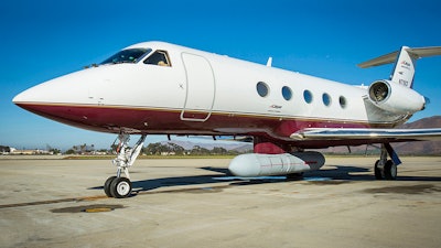 A Gulfstream business jet is fitted prototype of Raytheon’s Next Generation Jammer mounted beneath it.