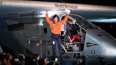 Pilot Bertrand Piccard emerges from Solar Impulse 2 at Moffett Field in Mountain View, Calif., on Saturday, April 23, 2016, after crossing the Pacific Ocean. The solar-powered airplane landed in California on Saturday, completing a risky, three-day flight across the Pacific Ocean as part of its journey around the world.
