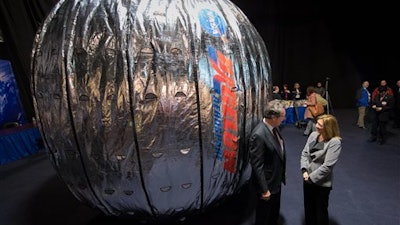 In this Wednesday, Jan. 16, 2013 photo made available by NASA, NASA Deputy Administrator Lori Garver and Robert T. Bigelow, president and founder of Bigelow Aerospace, stand next to the Bigelow Expandable Activity Module (BEAM) during a news conference in Las Vegas. It’s a technology demonstration meant to pave the way for moon bases and Mars expeditions, as well as orbiting outposts catering to scientists and tourists.