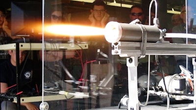 Students and faculty at Utah State University watch as a small rocket motor is tested. USU has developed a method to make a safer, next-generation motor using printed ABS plastic and inexpensive components.