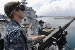 Gunners Mate 2nd Class Daniel Green, foreground, and Fire Controlman 3rd Class Tong Vang, right, defend against virtual enemy combatants during an Office of Naval Research (ONR) demonstration of new and improved virtual training programs that combine software and gaming technology to help naval forces plan for multiple missions and operations.