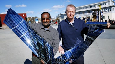 Polymer solar cells manufactured using low-cost roll-to-roll printing technology, demonstrated here by professors Olle Inganäs (right) and Shimelis Admassie.