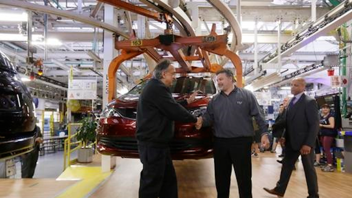 Fiat Chrysler Automobiles Chairman and CEO Sergio Marchionne, left, shakes hands with Dino Chiodo, president of Unifor Local 444 in front of a 2017 Pacifica minivan on the Windsor Assembly Plant line, Friday, May 6, 2016, in Windsor, Ontario. Fiat Chrysler and Google announced Tuesday, May 3, that they will work together to more than double the size of Google's self-driving vehicle fleet by adding 100 Chrysler Pacifica minivans.