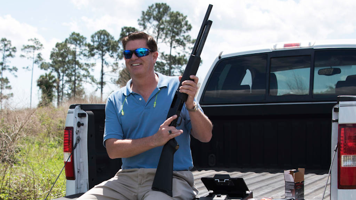 In this photo taken April 7, 2016, Jonathan Mossberg, whose iGun Technology Corp. is working to develop a 'smart gun,' poses with the firearm, in Daytona Beach, Fla. Mossberg is among a group of pioneers looking to build a safer gun. But unlike many others, he was in the gun business when he started down that path. Mossberg has been working to develop and someday bring to market a firearm that can't be fired by the wrong person, but works without fail in the hands of its owner in a life-or-death situation.