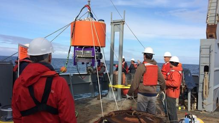In this May 23, 2016, photo provided by NOAA Northwest Fisheries, an automated laboratory that will analyze seawater for algae species and toxins is lowered by researchers into the Pacific about 13 miles from La Push, Wash. After a massive toxic algae bloom closed lucrative shellfish fisheries off the West Coast last year, scientists are now turning to the new tool, dubbed 'a laboratory in a can, that could provide early warning of future problems. It is expected to provide real-time data on concentrations of six species of microscopic algae and toxins they produce, including domoic acid.