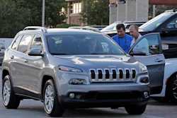 In this AP photo, salesperson Jerry Camero, right, delivers a 2016 Jeep Cherokee Limited to a customer. Major automakers reported sales figures on Tuesday, May 3, 2016.