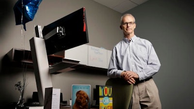 David McQuinn poses for a photo in his office at MiTek, a construction and engineering firm, Tuesday, May 10, 2016, in Chesterfield, Mo. McQuinn, 61, is retiring Tuesday after 30 years with the suburban St. Louis company, a length of time with one employer that is unlikely to be achieved by many younger workers.