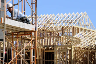 In this file photo, a carpenter works on the siding of a new townhouse. On Monday, May 16, 2016, the National Association of Home Builders/Wells Fargo releases its May index of builder sentiment.