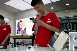 Chinese sales representatives wait for customers at a Huawei retails shop in Beijing, China. Chinese tech giant Huawei said Wednesday, May 25 it has filed patent infringement lawsuits against South Korean mobile phone rival Samsung in the United States and China, in a case that highlights the rise of Asian competitors as technology creators.