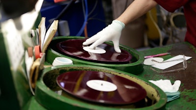 A worker checks a pressed record at a vinyl plant in Lodenice, Czech Republic. As vinyl records make a global comeback in popularity, a little-known Czech company is riding the market surge to establish itself as the world’s biggest record manufacturer.