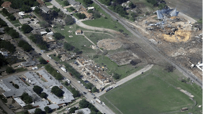 This April 18, 2013 aerial file photo shows the remains of a nursing home, left, apartment complex, center, and fertilizer plant, right, destroyed by an explosion at a fertilizer plant in West, Texas. Federal authorities announced Wednesday, May 11, 2016, that the fire that caused the deadly explosion in 2013 was a criminal act. The explosion killed 15 people, injured hundreds and left part of the small town in ruins.