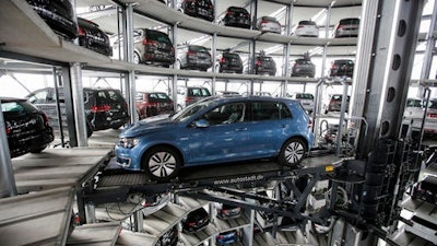 In this April 28, 2016 file photo a Golf Volkswagen car is presented to media inside a delivery tower prior to the company's annual press conference in Wolfsburg, Germany. Volkswagen will announce its first quarter earnings on May, 31, 2016.