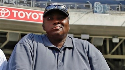In this June 11, 2013 file photo, Hall of Famer Tony Gwynn watches batting practice during warmups prior to a baseball game between the San Diego Padres and the Atlanta Braves in San Diego. Gwynn's widow and two children filed a lawsuit Monday, May 23, 2016, seeking to hold the tobacco industry accountable for the Hall of Famer's death.