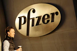 In this file photo, a man enters Pfizer's world headquarters, in New York. Pfizer is buying Anacor Pharmaceuticals Inc. in a deal announced Monday, May 16, 2016.