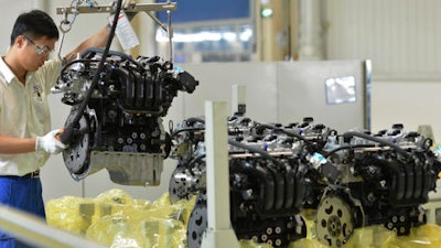 A worker arranges engine blocks at the General Motors assembly plant in Wuhan in central China's Hubei province.