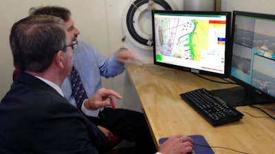 U.S. Defense Secretary Ashton Carter, foreground, uses a computer to set the course for an unmanned surface vehicle in adjacent the bay at Naval Undersea Warfare Center Wednesday, May 25, 2016, in Newport, R.I. Carter told students at the nearby U.S. Naval War College in Newport that the government needs to develop technology faster and reconnect with the tech industry.