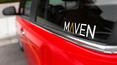 This Wednesday, April 27, 2016, photo, shows the Maven logo on a General Motors car-sharing service automobile, in Ann Arbor, Mich. Automakers are reinventing themselves as 'mobility' companies that can accommodate all the different ways people get around. Already this year, General Motors Co. has announced a long-term alliance with ride-hailing company Lyft and started car-sharing service Maven.