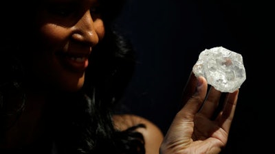 A model displays a large diamond at Sotheby's in New York, Wednesday, May 4, 2016. The auction house plans to offer the Lesedi la Rona diamond in London on June 29.