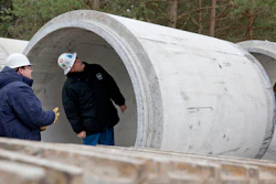 In this Nov. 26, 2013 file photo, Karegnondi Water Authority CEO Jeff Wright, right, and Deputy CEO John O'Brien look inside a pipe that will be part of the Karegnondi Pipeline Project, in Worth Township, Mich. After months of national attention on lead-tainted drinking water in Flint, many are starting to ask questions about the 74-mile pipeline being built from Lake Huron to the struggling former auto manufacturing powerhouse.
