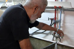 This Tuesday, May 24, 2016, image taken from video shows David G. Mata Sr. turning on the faucet in the basement of his home in Flint, Mich. State and local officials are asking Flint residents to flush the pipes in their homes every day for two weeks. Some residents like Mata are giving it a shot, but not all believe the effort will have its intended effect of helping to remove lead particles and coat the pipes.